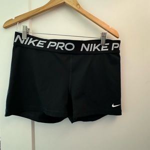 three pairs of Nike pros